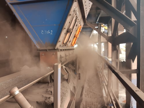 Dust billowing from a conveyor tranfer point can be a big problem if left untreated. MSHA's new rule will be strongly enforced once passed. 