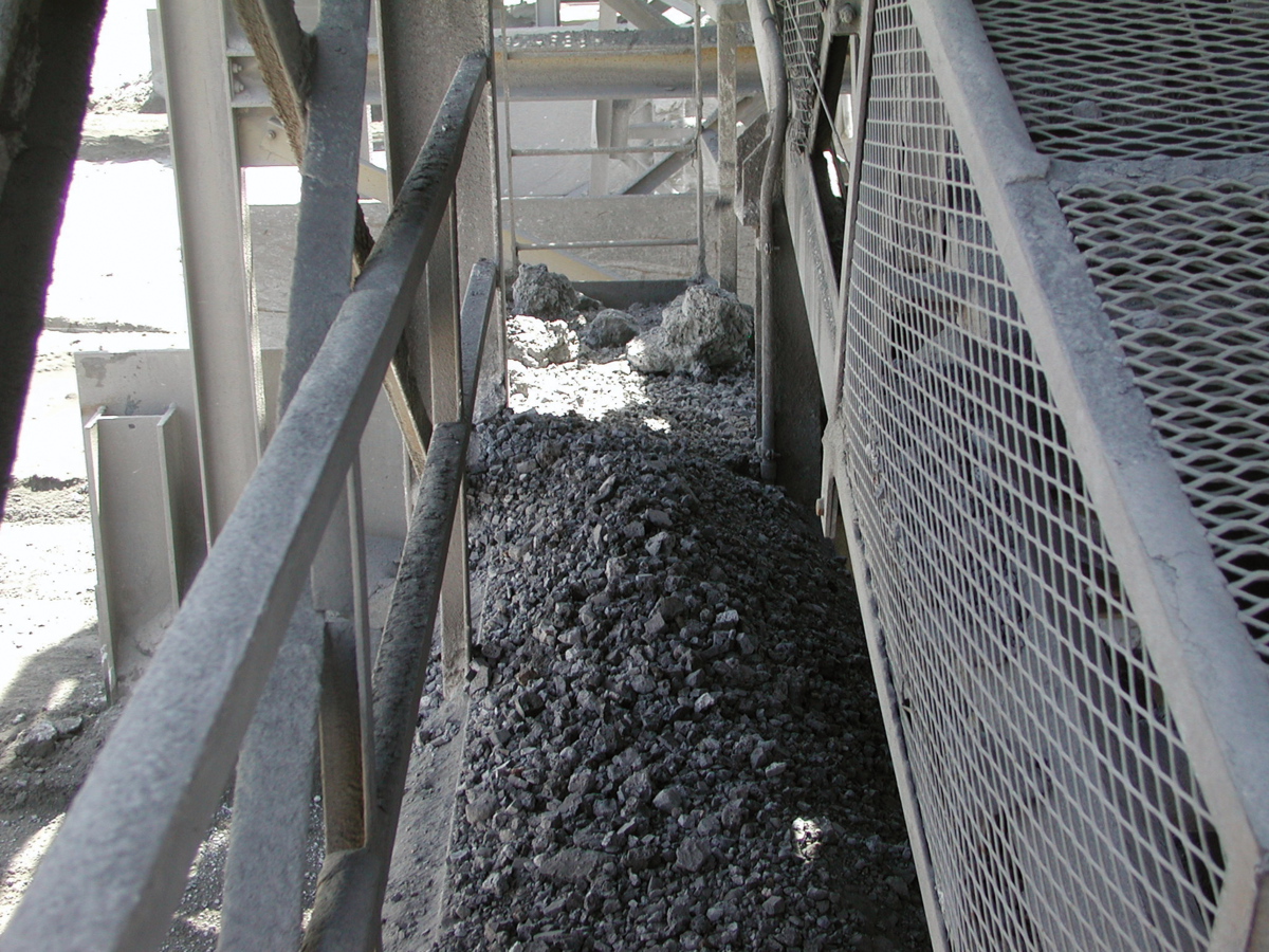 Fugitive material obstructing conveyor walkways is an offensible safety hazard