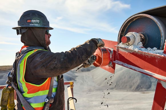 service-technician-conveyor-belt-cleaner-tensioner-inspection-adjustment-maintenance